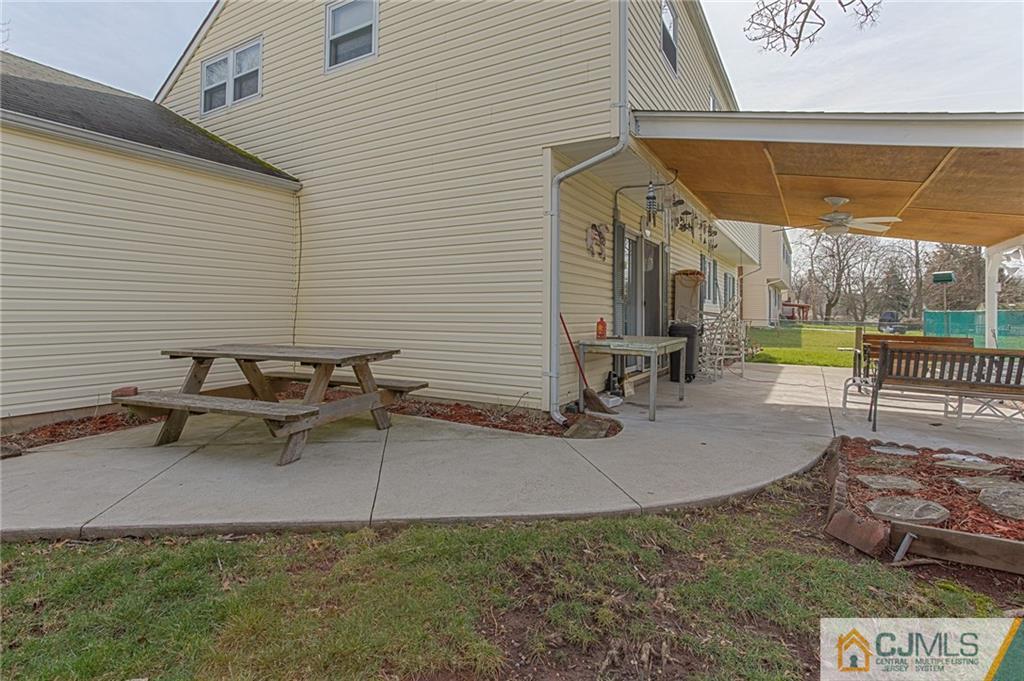 16 Fulton Road Somerset, NJ 08873 - Photo 21 of 25 a view of a patio with a table and chairs