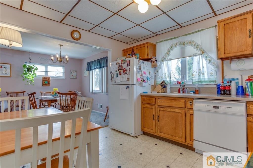 16 Fulton Road Somerset, NJ 08873 - Photo 4 of 25 a kitchen with stainless steel appliances granite countertop a refrigerator and cabinets