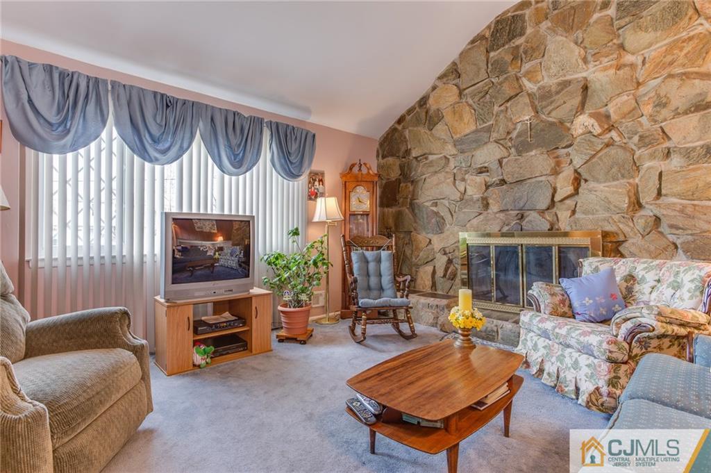 16 Fulton Road Somerset, NJ 08873 - Photo 7 of 25 a living room with furniture a fireplace and a flat screen tv