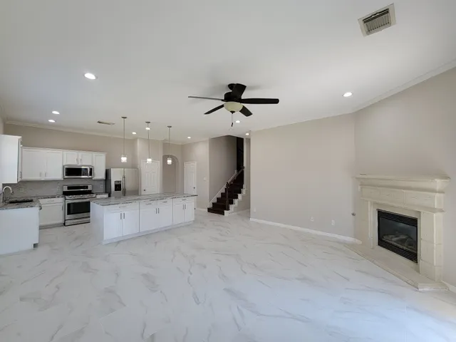 a view of kitchen with refrigerator stove microwave and cabinets