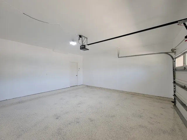 a view of a room with a ceiling fan and window