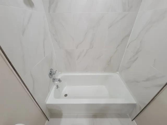 a bathroom with bathtub and shower