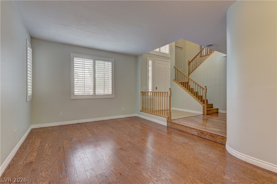 1813 Snow Spring Lane Las Vegas, NV 89134 - Photo 8 of 37 Rich hardwood flooring guides you through this home's welcoming entry and open living space.
