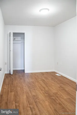 a view of an empty room and closet area