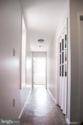 a view of a hallway with wooden shelves