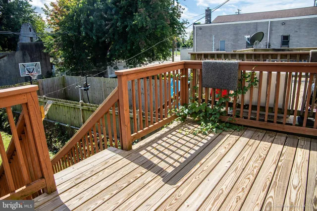 a view of balcony with wooden floor and outdoor seating