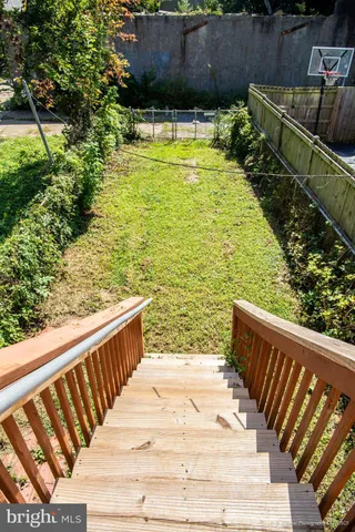 a view of a swimming pool with a patio and plants