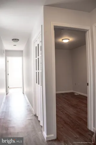 a view of hallway with wooden floor