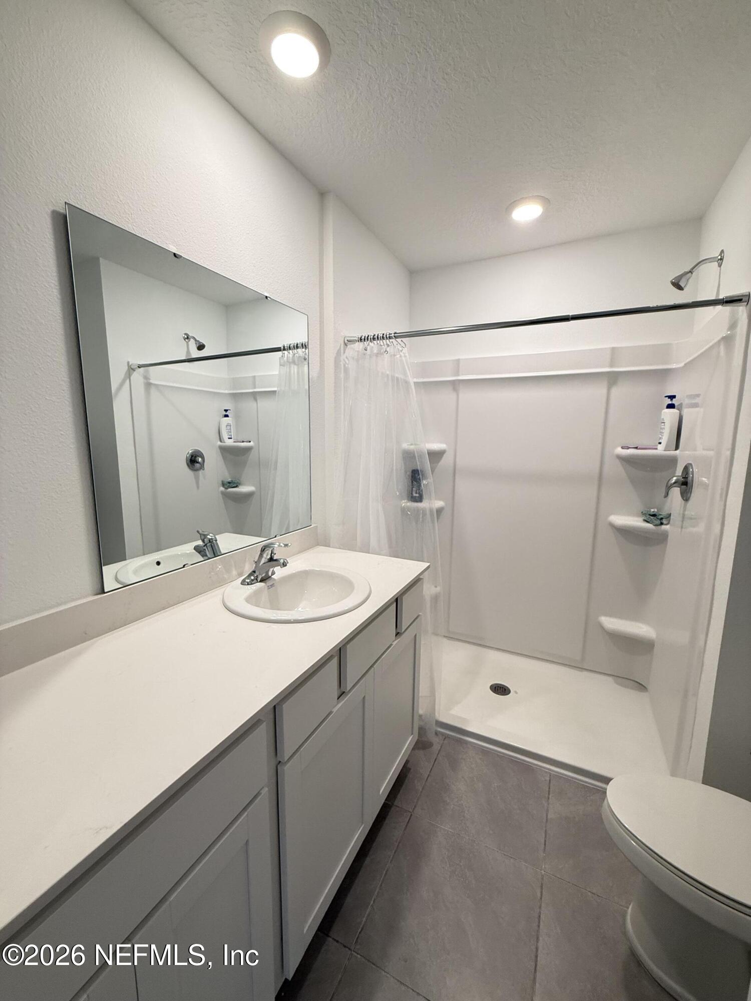 88 Crisanto Road St. Augustine, FL 32084 - Photo 11 of 21 a bathroom with a sink a toilet and shower