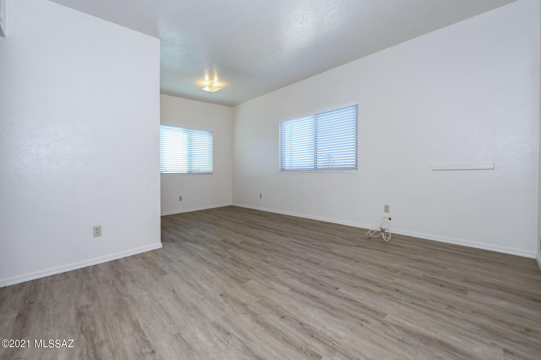 312 East 24th Street, Unit 4 Tucson, AZ 85713 - Photo 4 of 17 an empty room with wooden floor and windows