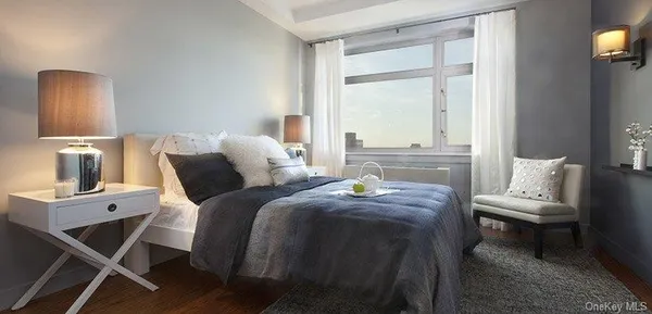a living room with a bed furniture and a window