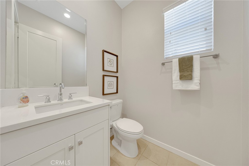 104 Sculpture Irvine, CA 92618 - Photo 15 of 36 a bathroom with a toilet sink and mirror