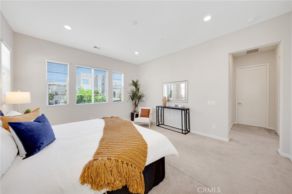 104 Sculpture Irvine, CA 92618 - Photo 20 of 36 a spacious bedroom with a large bed and a window