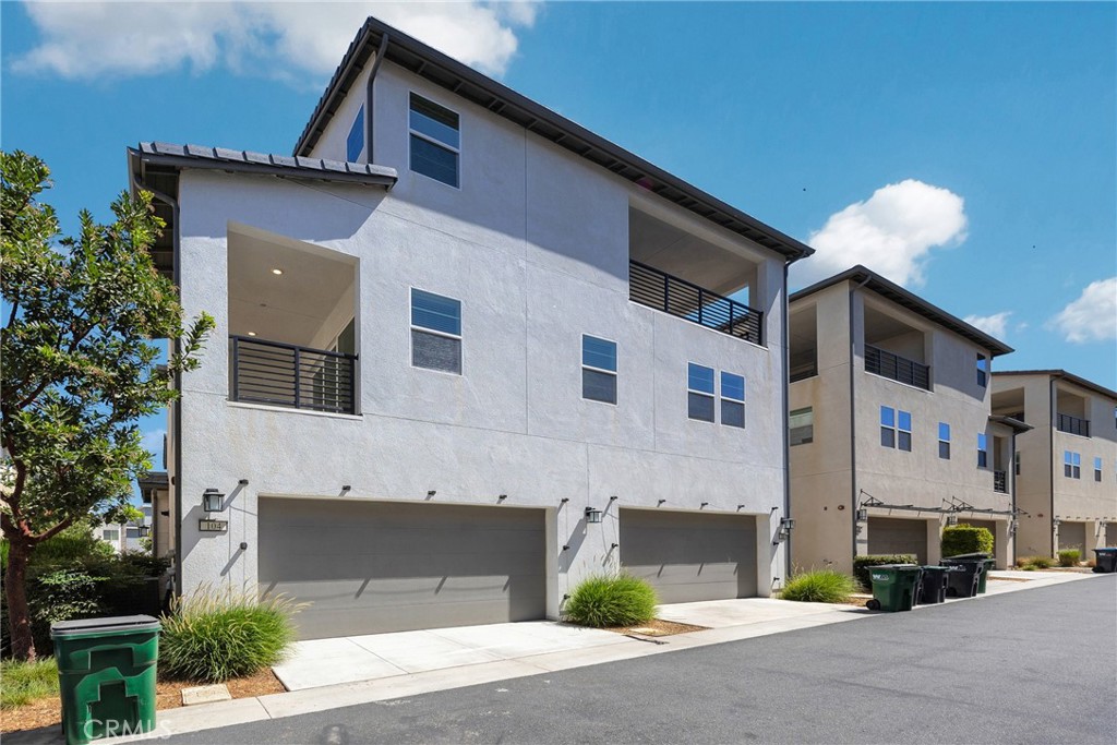 104 Sculpture Irvine, CA 92618 - Photo 29 of 36 a front view of a building with a road and plants