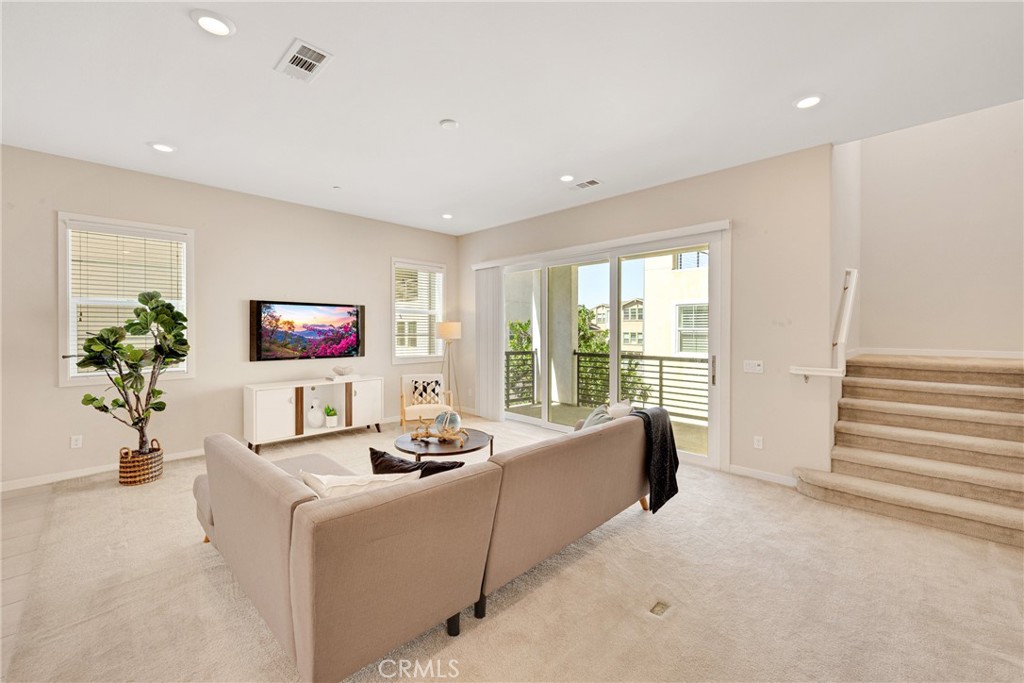104 Sculpture Irvine, CA 92618 - Photo 8 of 36 a living room with furniture a flat screen tv and a large window