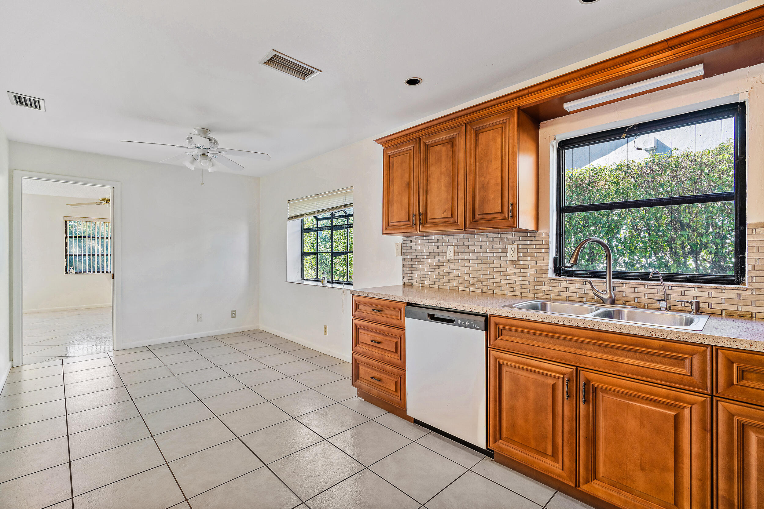 7938 Cloverfield Circle Boca Raton, FL 33433 - Photo 11 of 27 a kitchen with stainless steel appliances granite countertop a sink and a cabinets