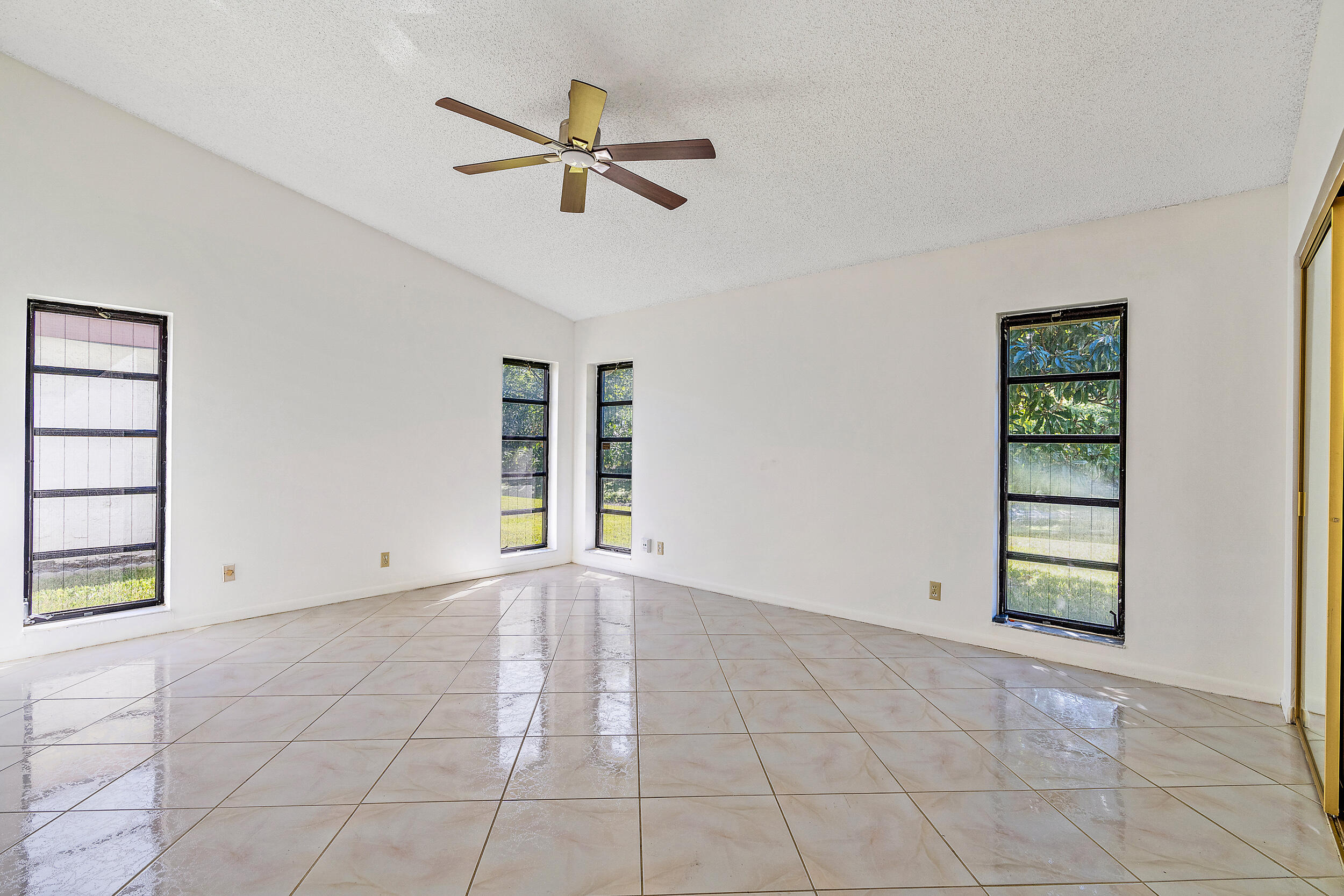 7938 Cloverfield Circle Boca Raton, FL 33433 - Photo 12 of 27 a view of an empty room with a window and kitchen view