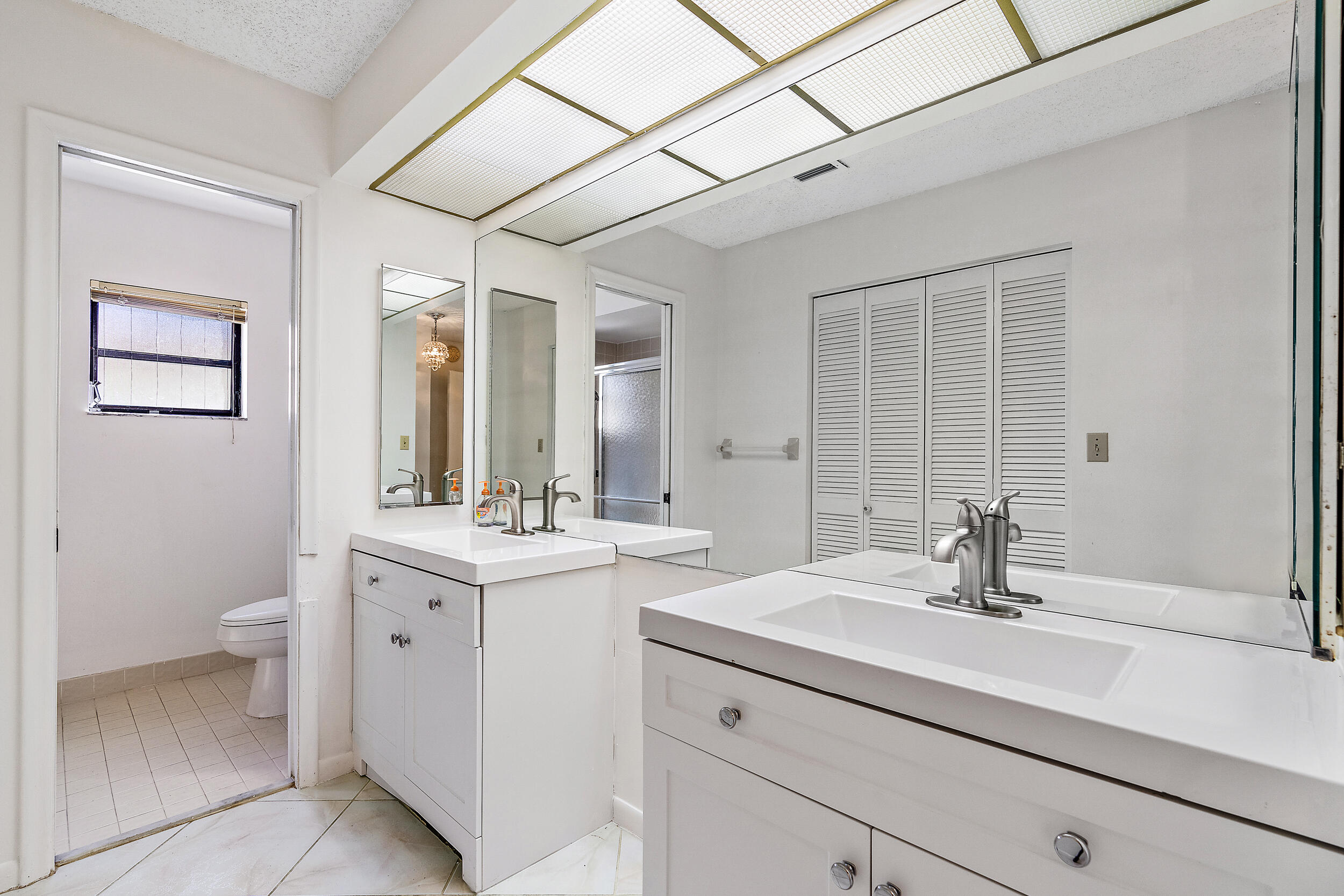 7938 Cloverfield Circle Boca Raton, FL 33433 - Photo 14 of 27 a bathroom with a sink and a mirror