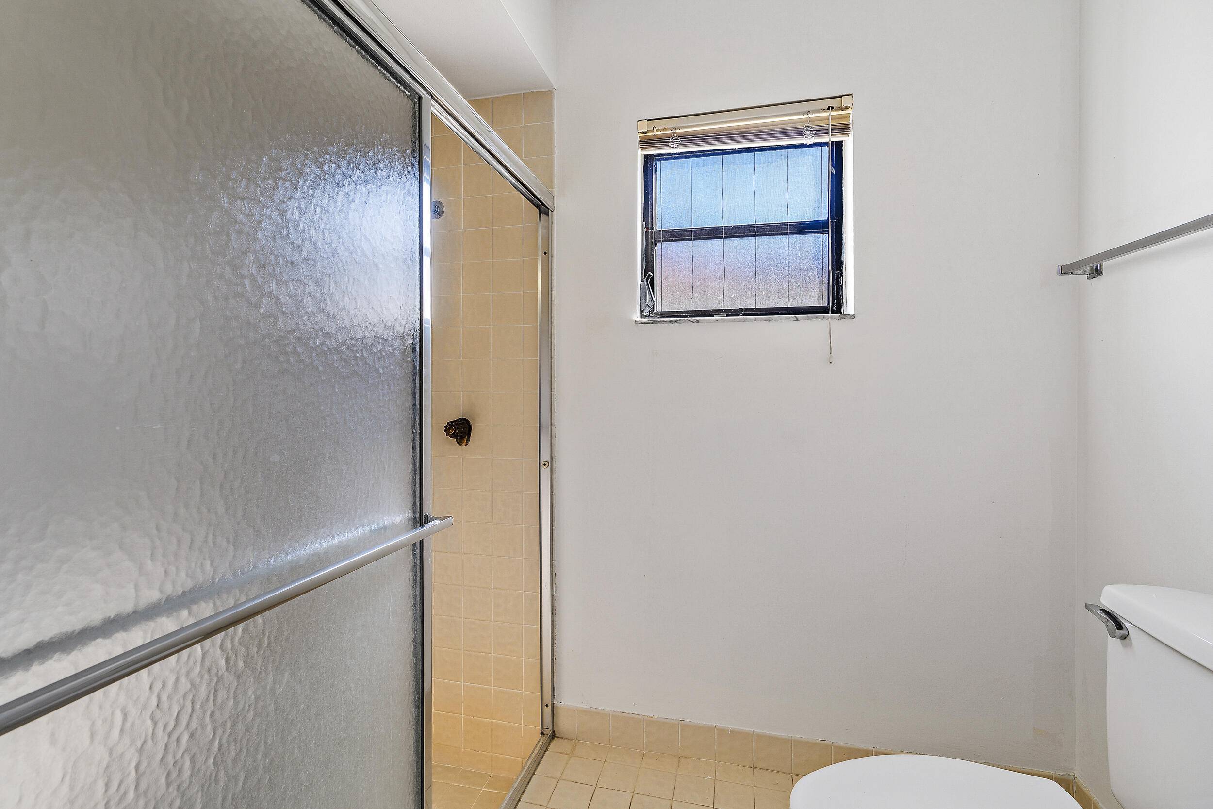 7938 Cloverfield Circle Boca Raton, FL 33433 - Photo 15 of 27 a bathroom with a toilet and a shower