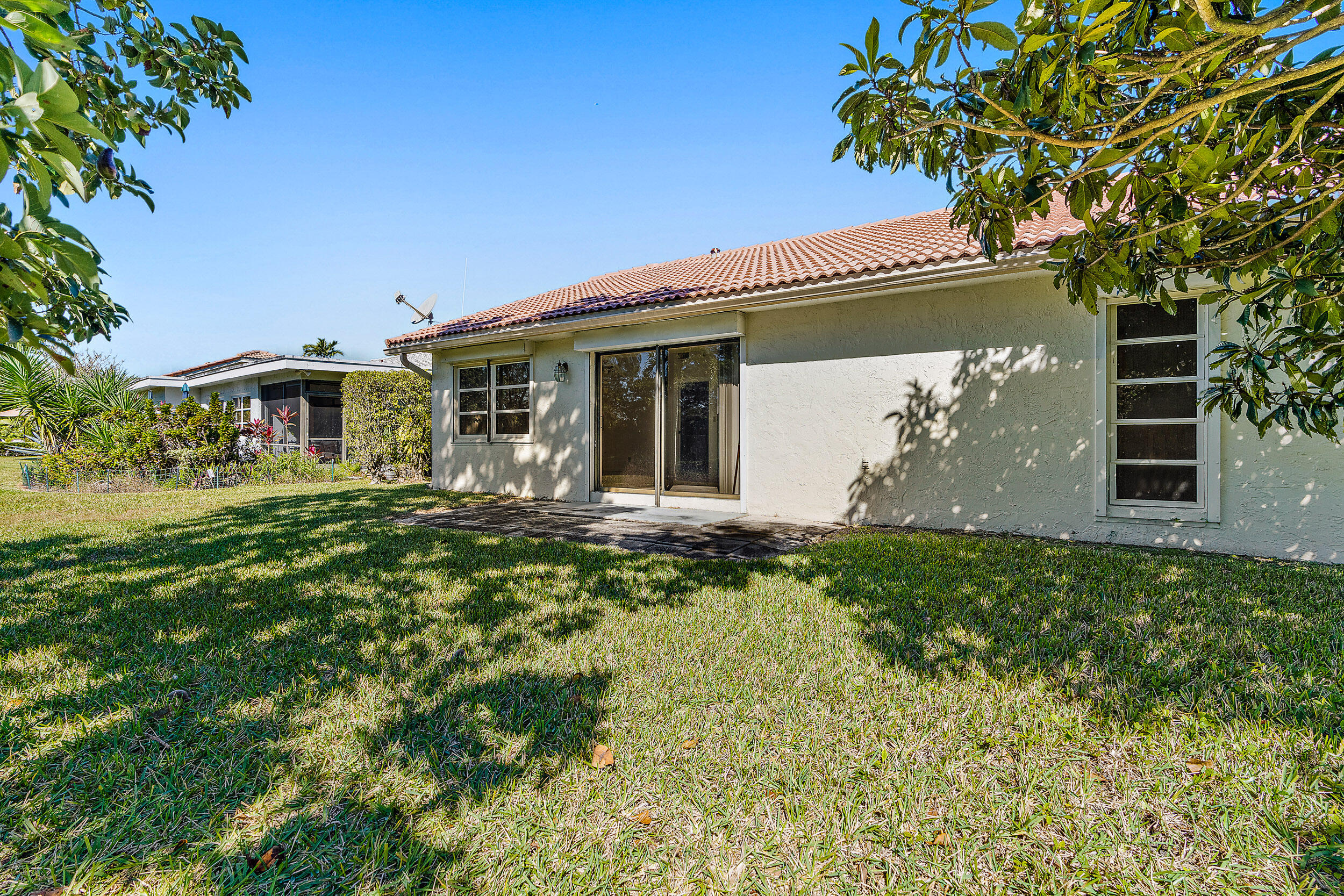 7938 Cloverfield Circle Boca Raton, FL 33433 - Photo 2 of 27 a front view of a house with garden