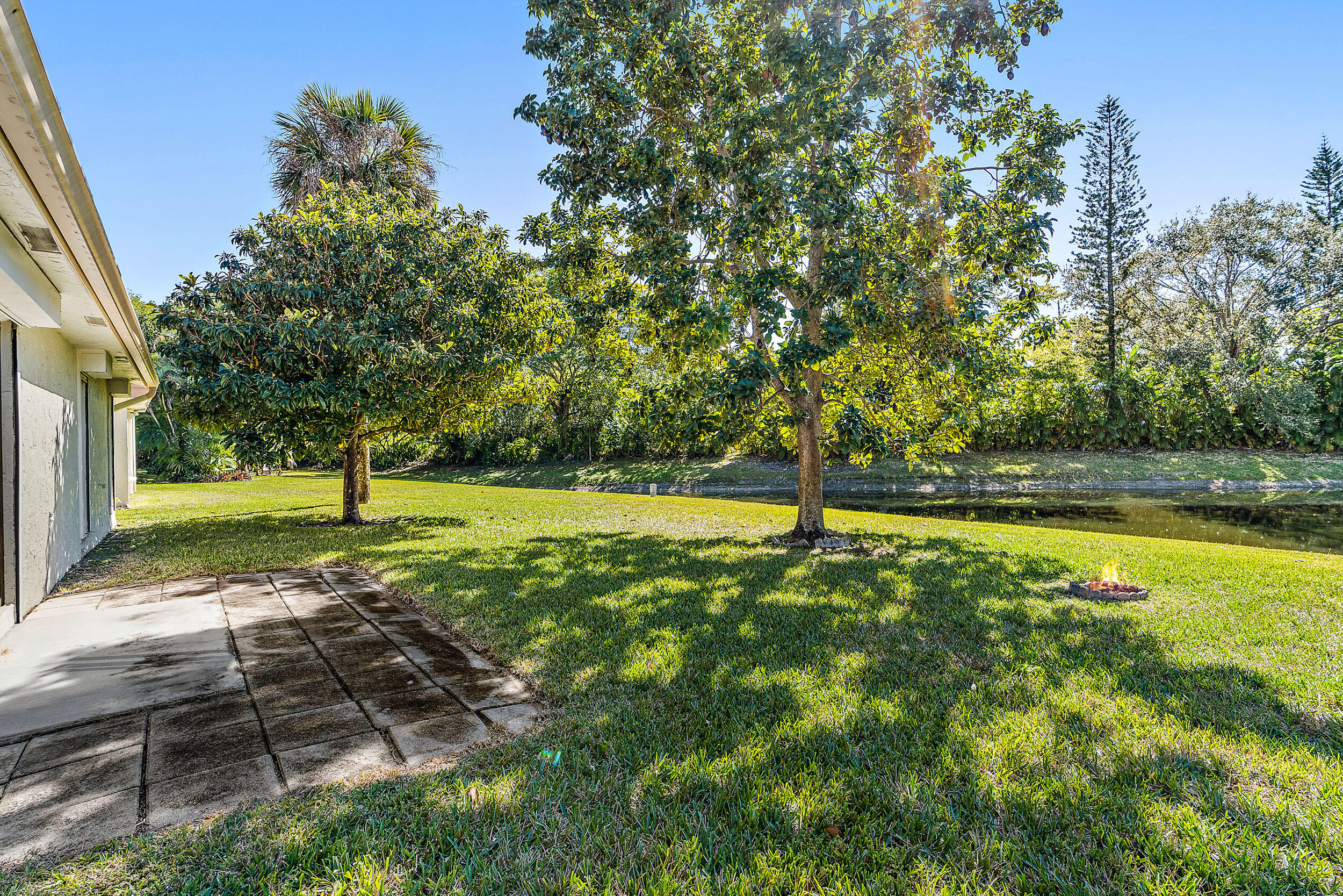 7938 Cloverfield Circle Boca Raton, FL 33433 - Photo 22 of 27 a view of a yard with swimming pool