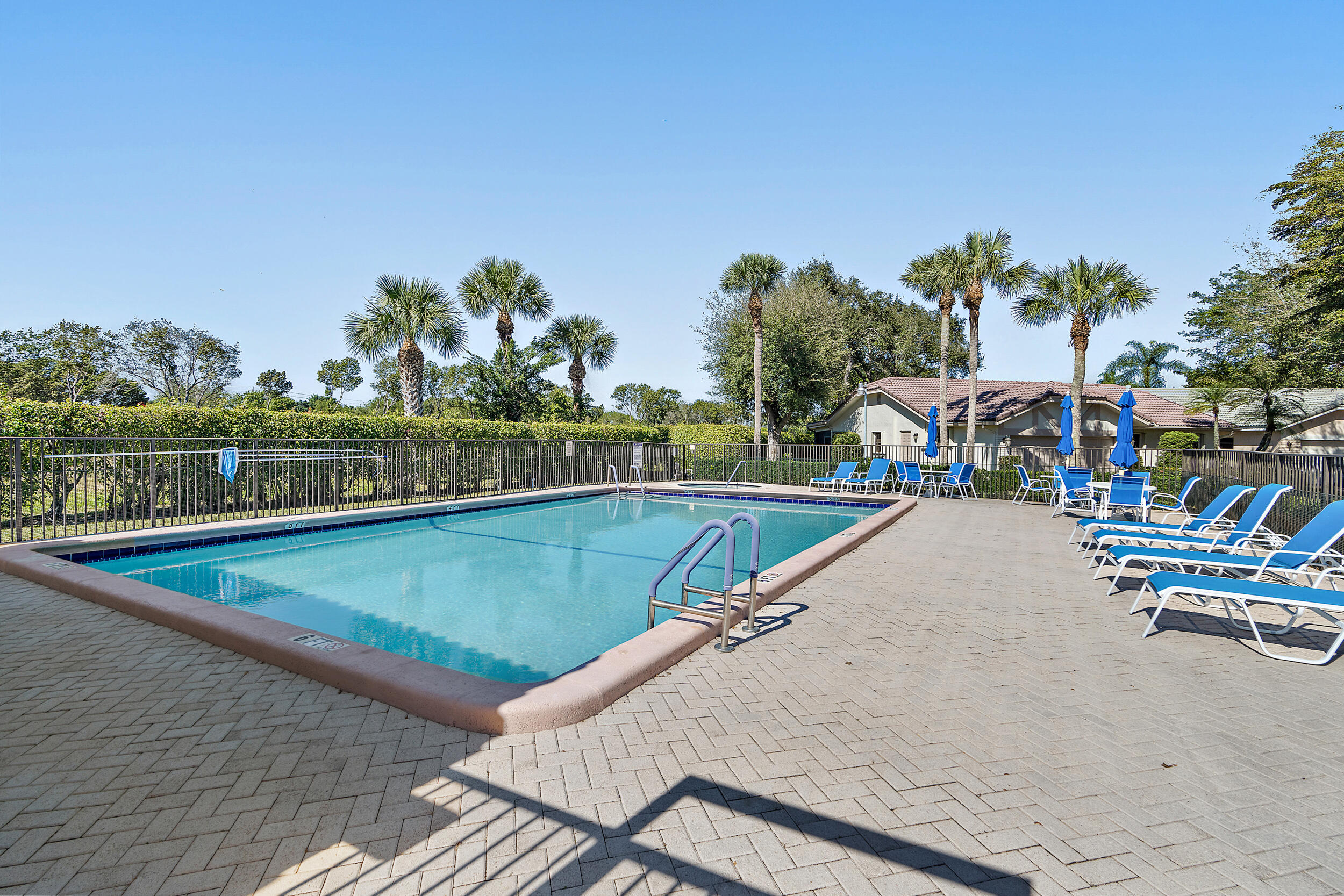 7938 Cloverfield Circle Boca Raton, FL 33433 - Photo 27 of 27 a view of a swimming pool with a lawn chairs