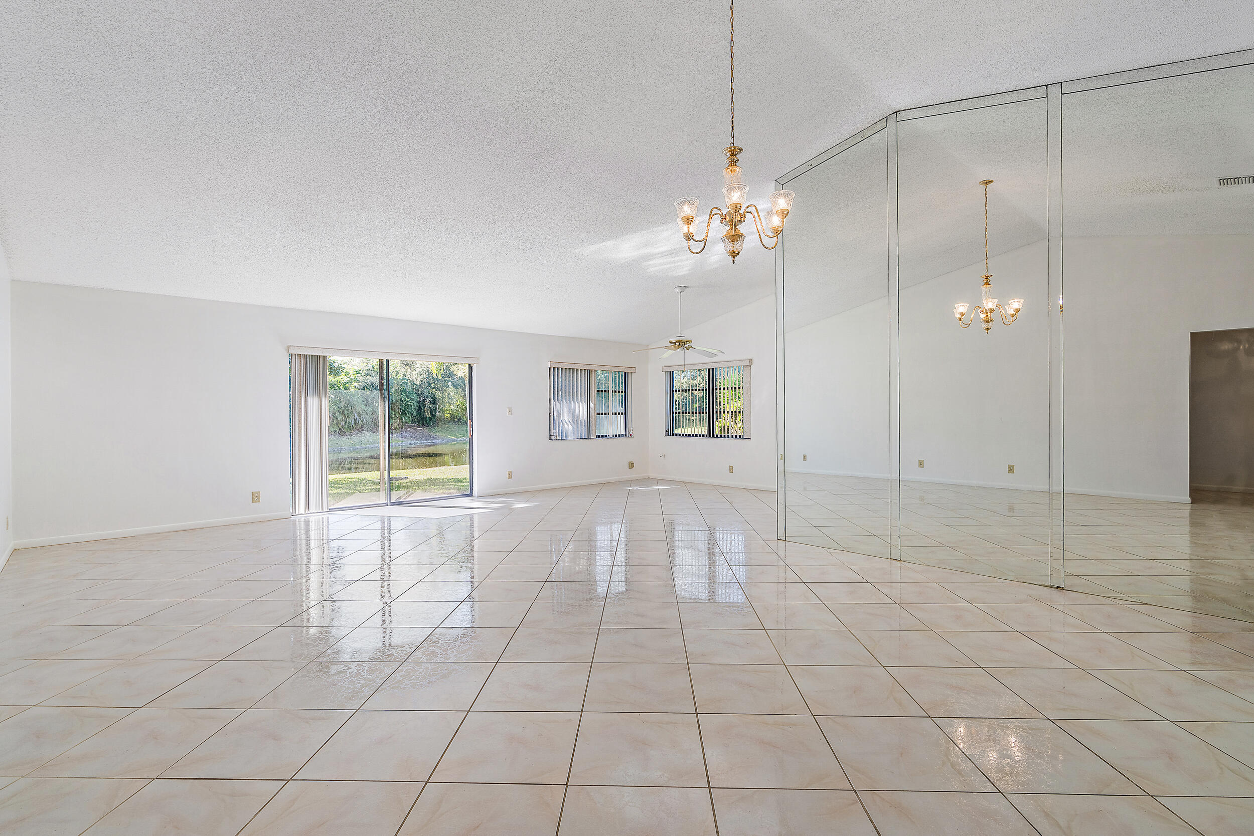 7938 Cloverfield Circle Boca Raton, FL 33433 - Photo 4 of 27 a view of a livingroom with a chandelier fan and windows