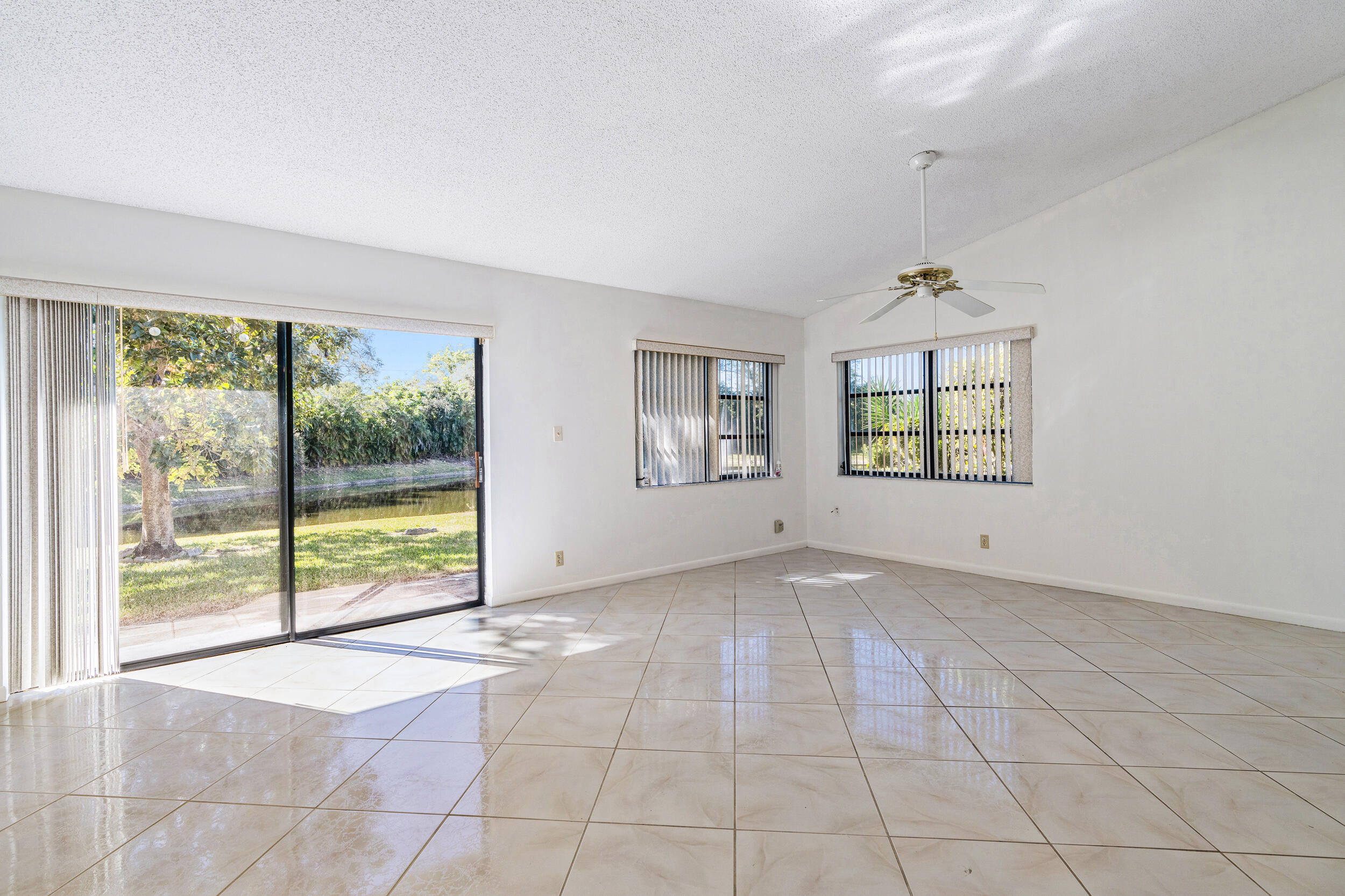 7938 Cloverfield Circle Boca Raton, FL 33433 - Photo 6 of 27 an empty room with windows