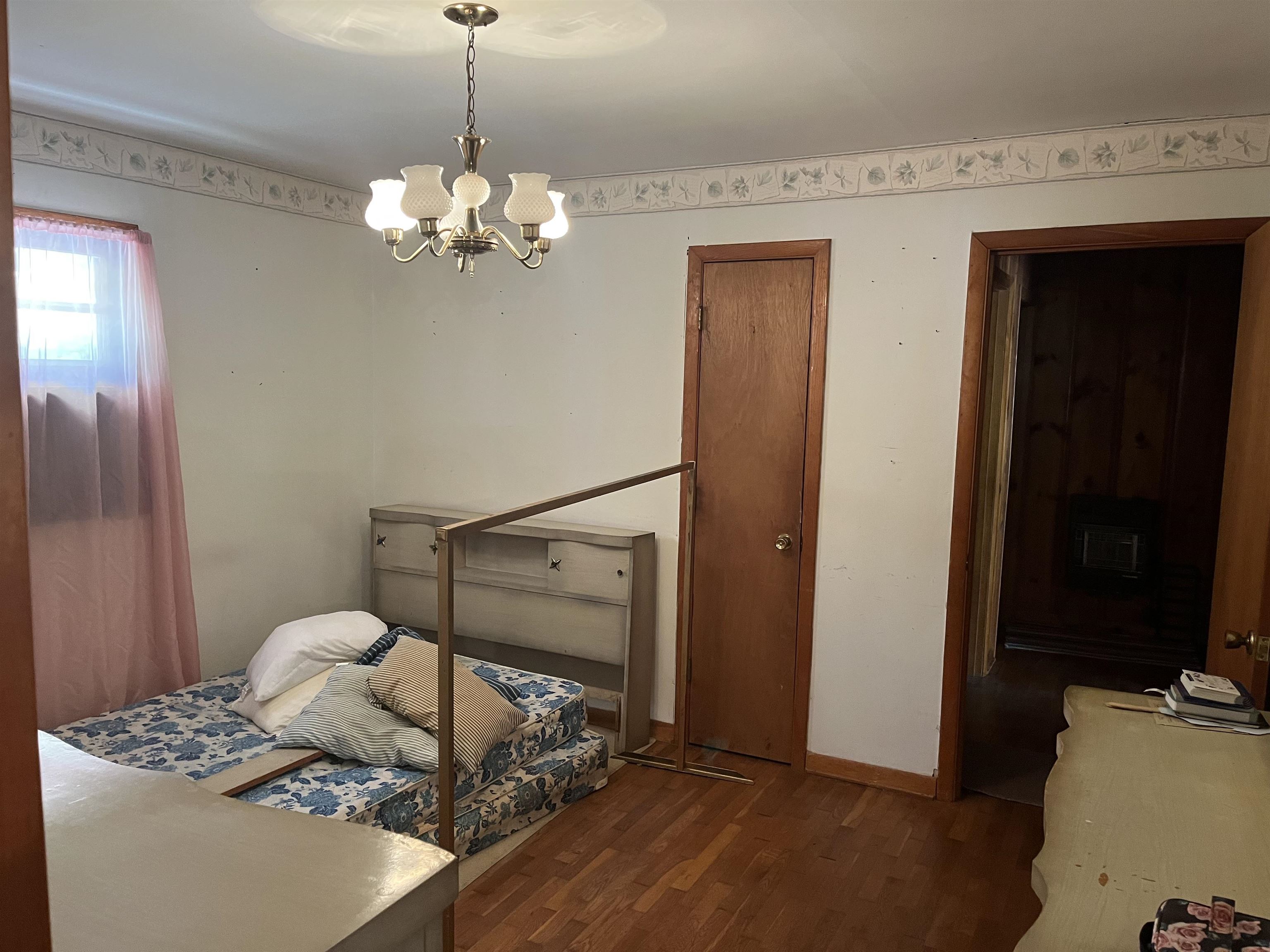 2168 Shawnettee Road Collinwood, TN 38450 - Photo 23 of 25 a bedroom with a bed and a chandelier
