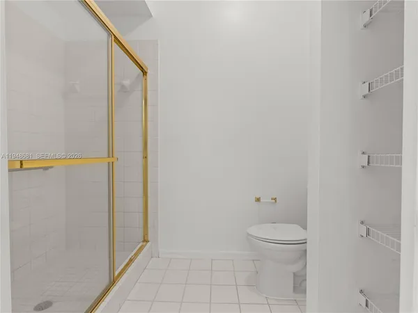 a view of a backyard with potted plants and a large tree