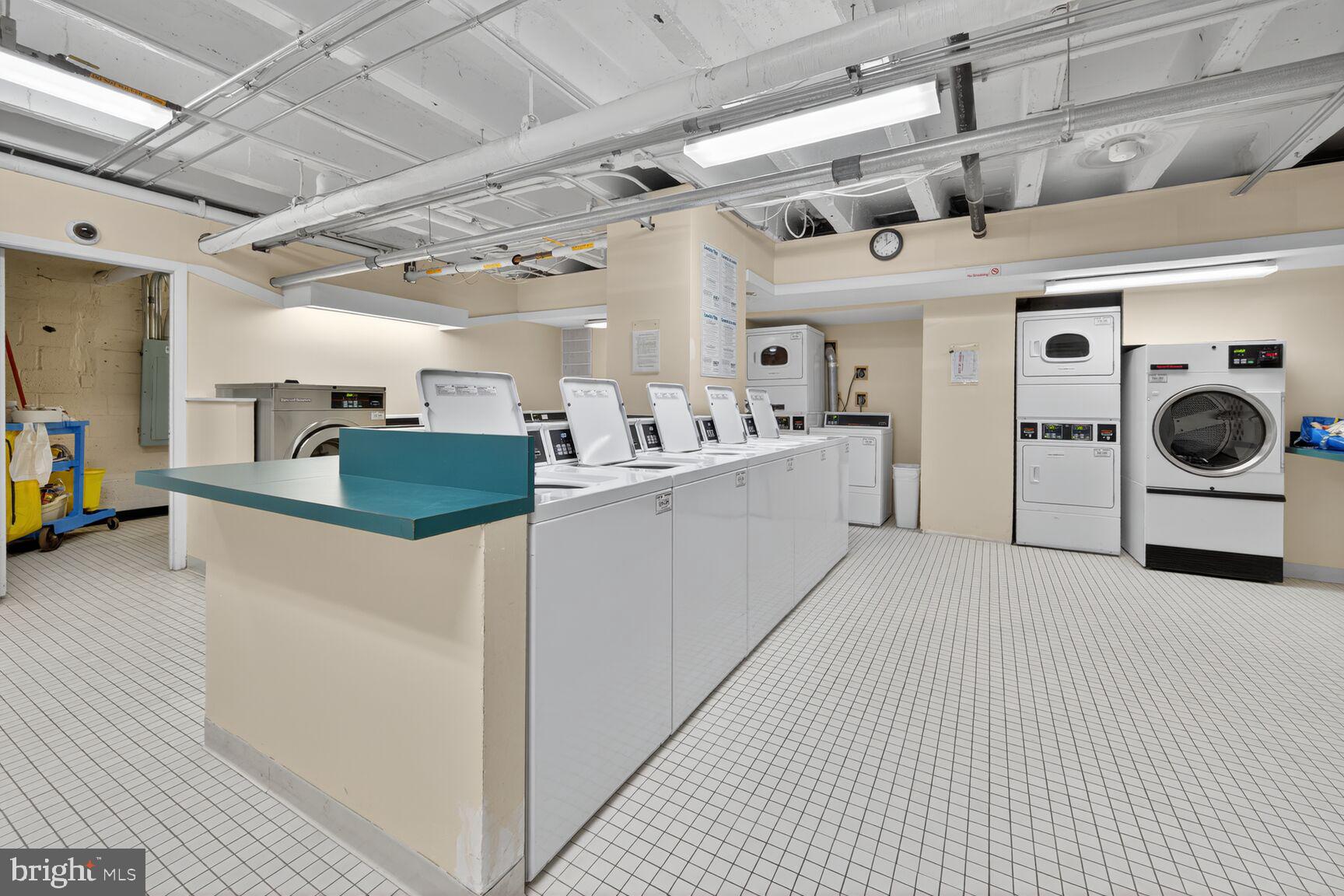 4301 Massachusetts Avenue Northwest, Unit 5009 Washington, DC 20016 - Photo 13 of 14 a kitchen with stainless steel appliances kitchen island granite countertop lots of white cabinets a refrigerator and a stove