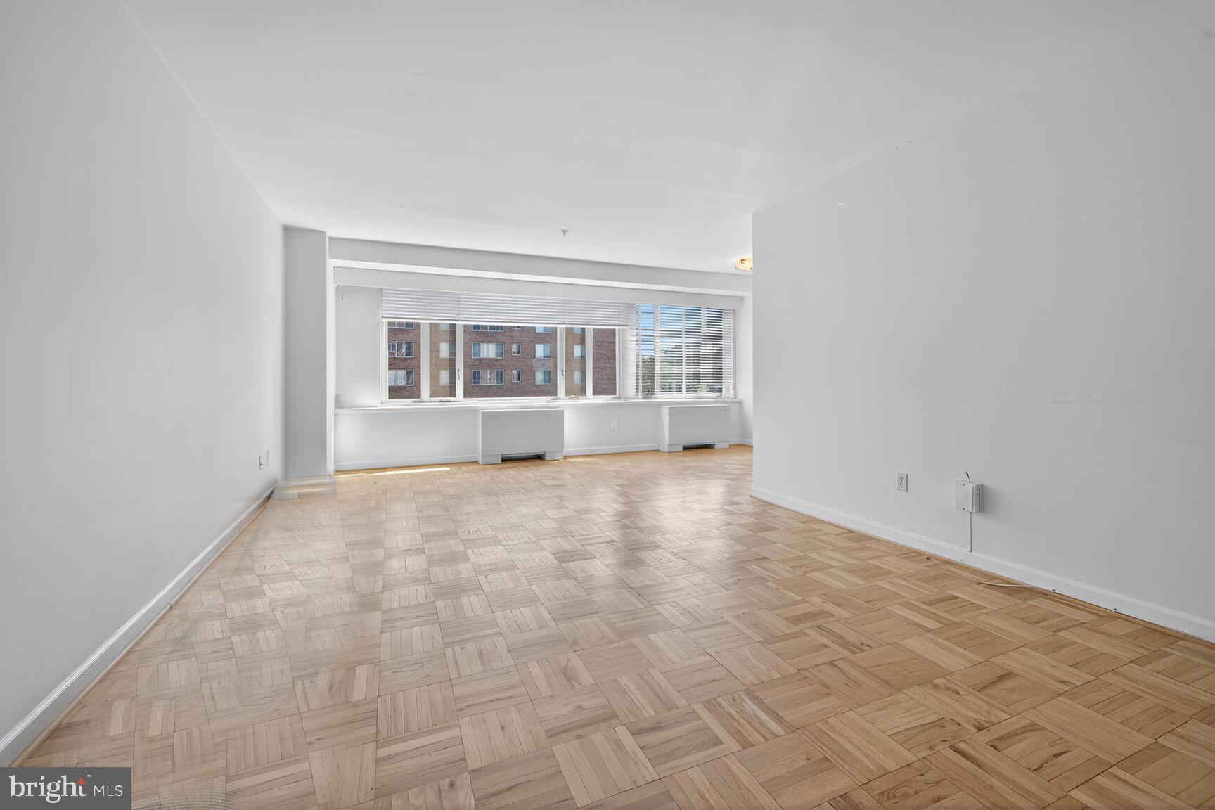 4301 Massachusetts Avenue Northwest, Unit 5009 Washington, DC 20016 - Photo 2 of 14 an empty room with windows