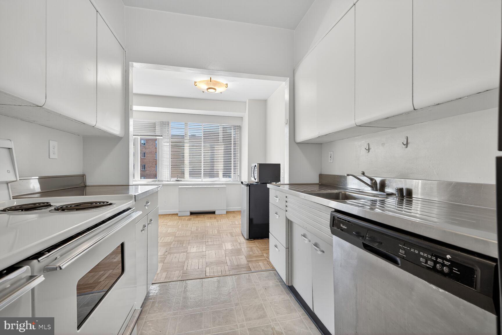 4301 Massachusetts Avenue Northwest, Unit 5009 Washington, DC 20016 - Photo 3 of 14 a kitchen with a sink stove top oven and cabinets