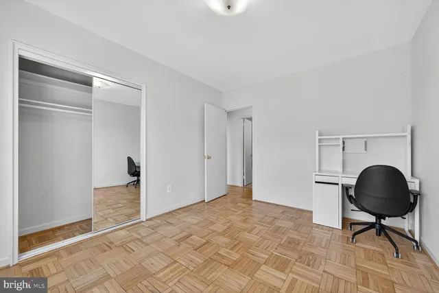 a room with a chair and a floor to ceiling window