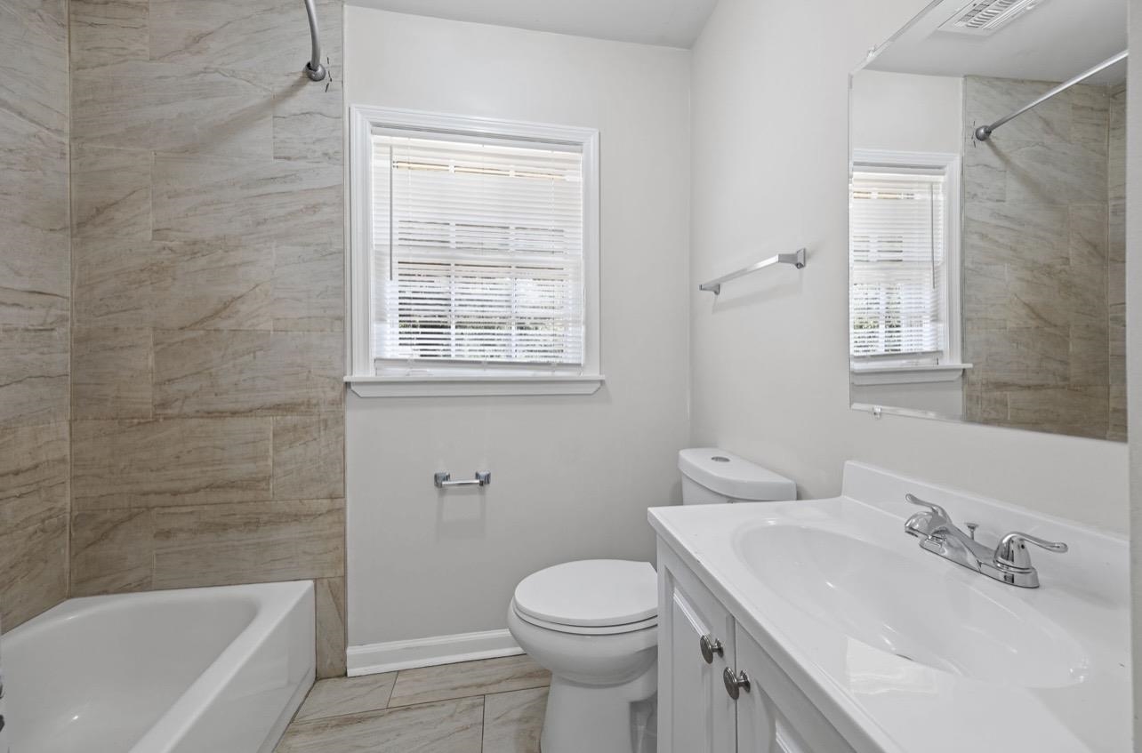 3843 Blue Jay Road Memphis, TN 38116 - Photo 14 of 23 Bathroom with vanity, bathing tub / shower combination, and light marble finish flooring