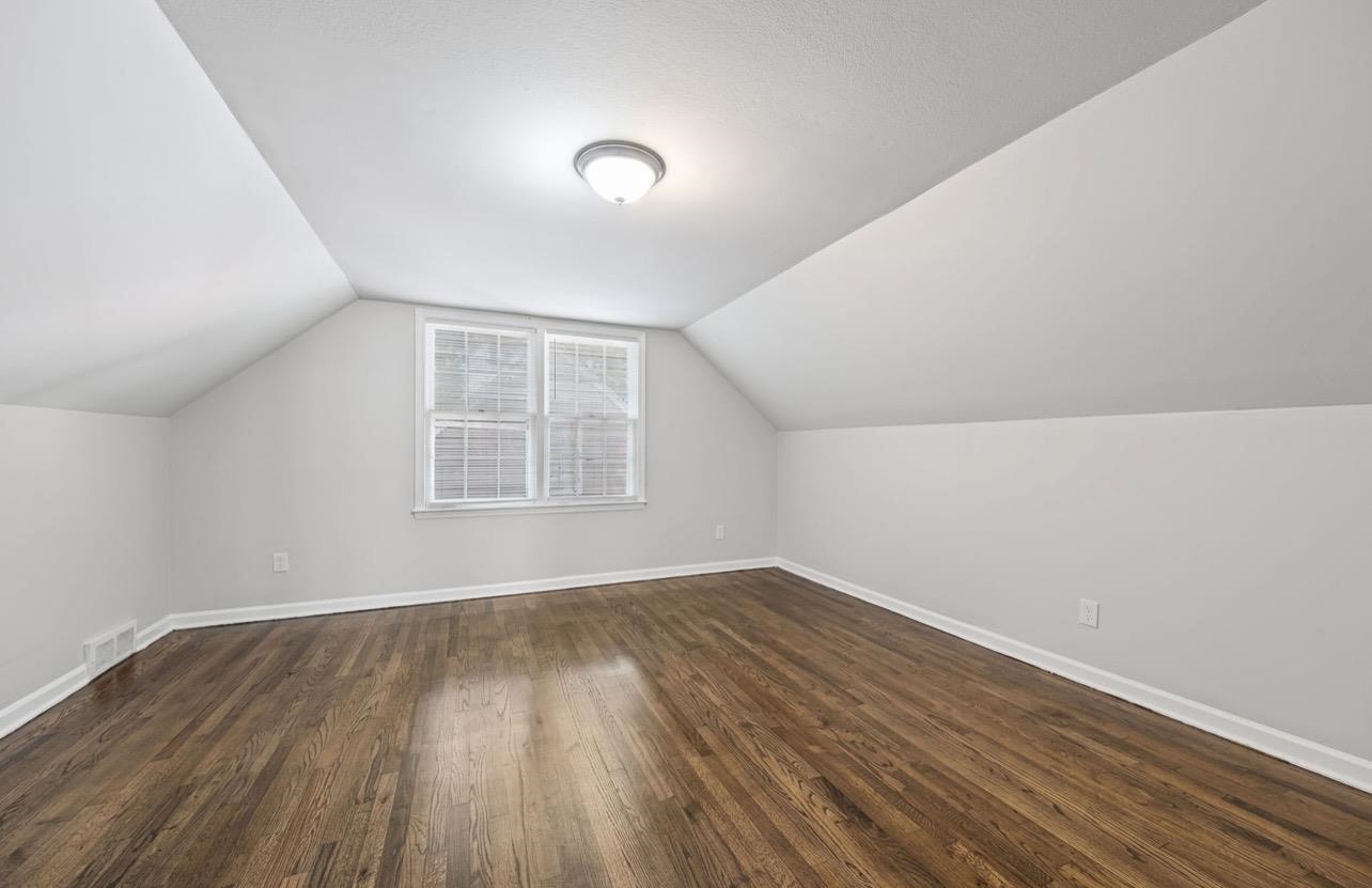 3843 Blue Jay Road Memphis, TN 38116 - Photo 20 of 23 Additional living space featuring dark wood-style floors and baseboards