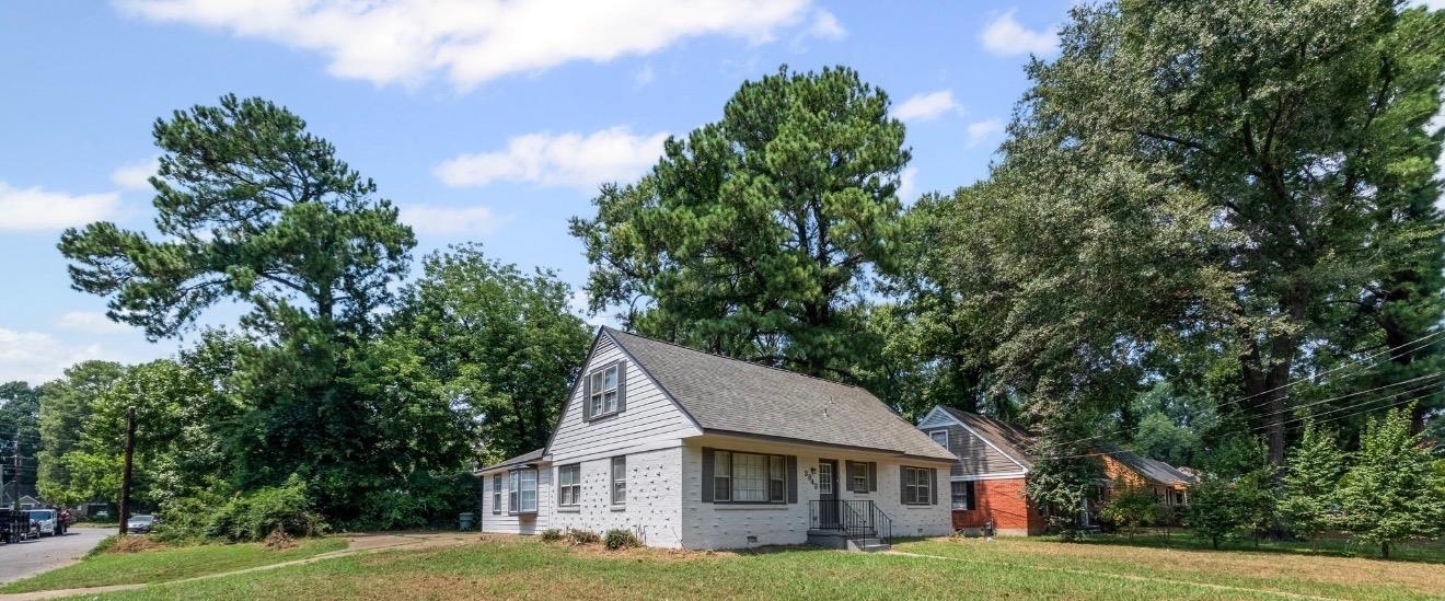 3843 Blue Jay Road Memphis, TN 38116 - Photo 3 of 23 View of front of house featuring brick siding, a front lawn, a shingled roof, view of wooded area, and crawl space