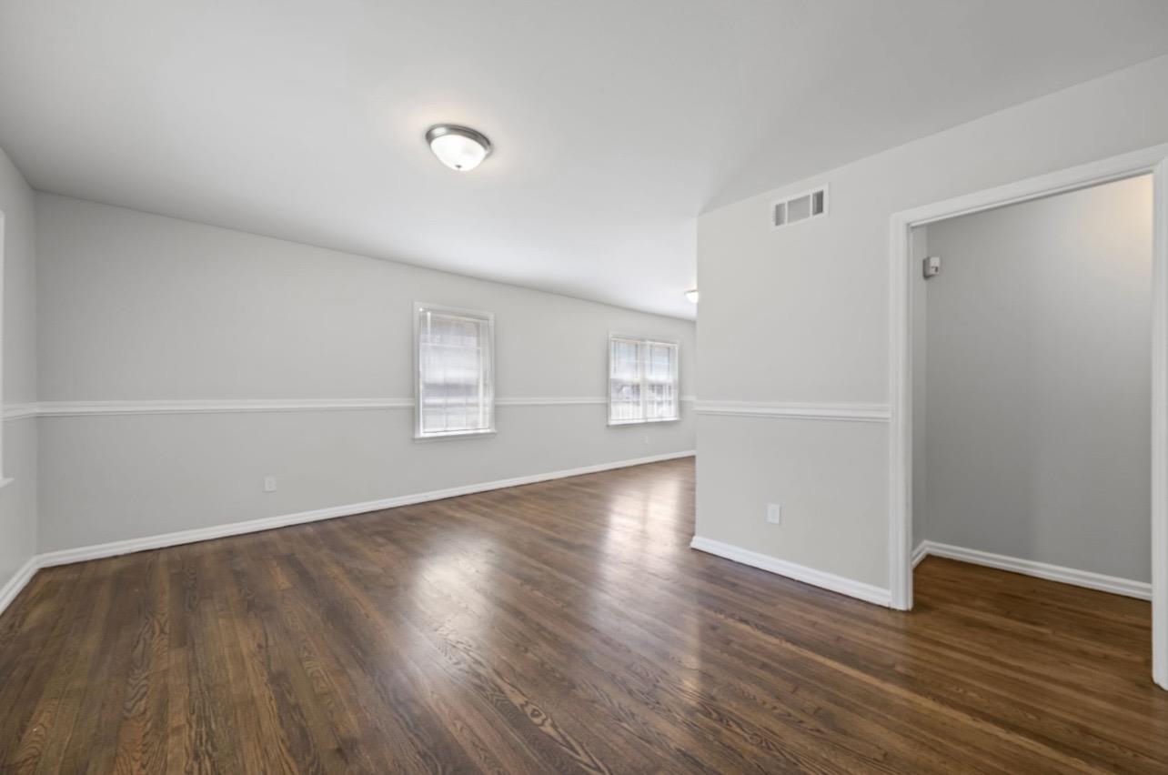 3843 Blue Jay Road Memphis, TN 38116 - Photo 5 of 23 Empty room with dark wood-type flooring and baseboards