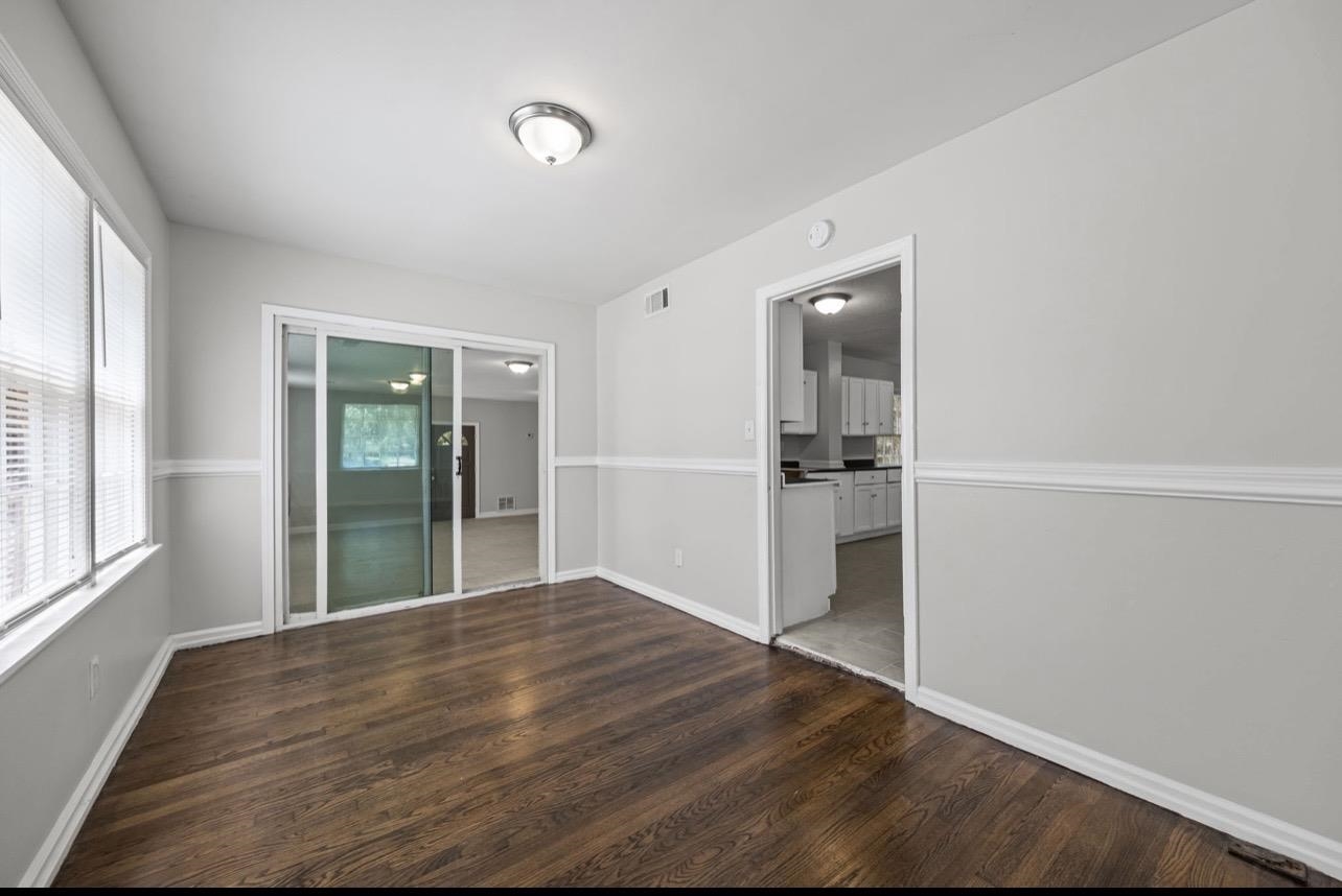 3843 Blue Jay Road Memphis, TN 38116 - Photo 8 of 23 Spare room featuring dark wood-type flooring and baseboards
