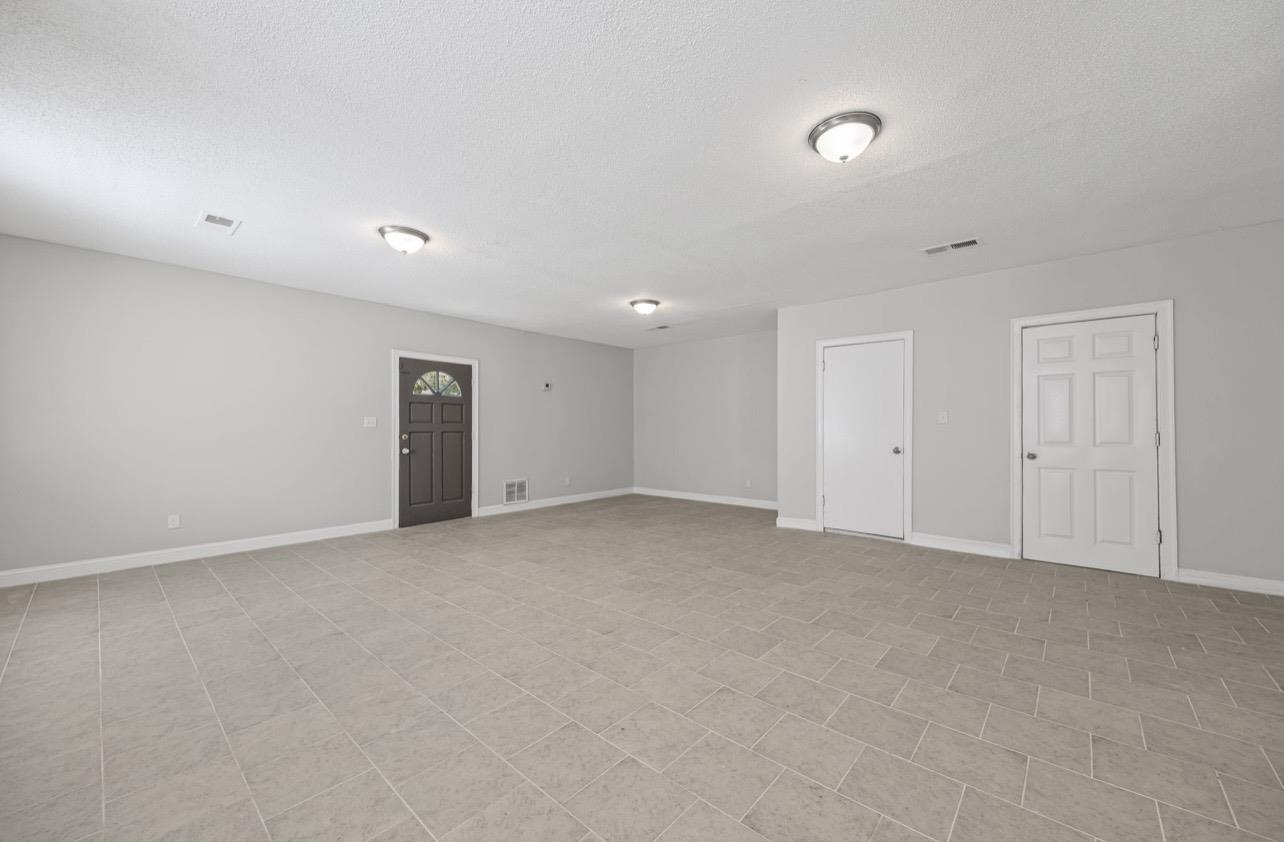 3843 Blue Jay Road Memphis, TN 38116 - Photo 9 of 23 Empty room with baseboards and a textured ceiling