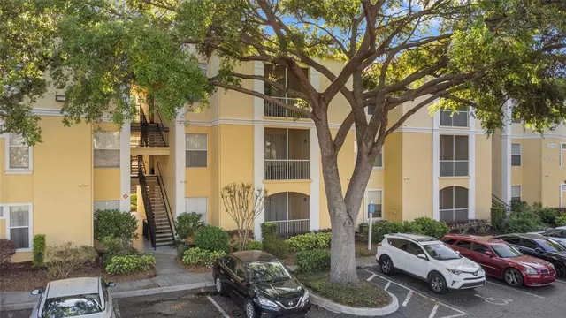 a couple of cars parked in front of a house