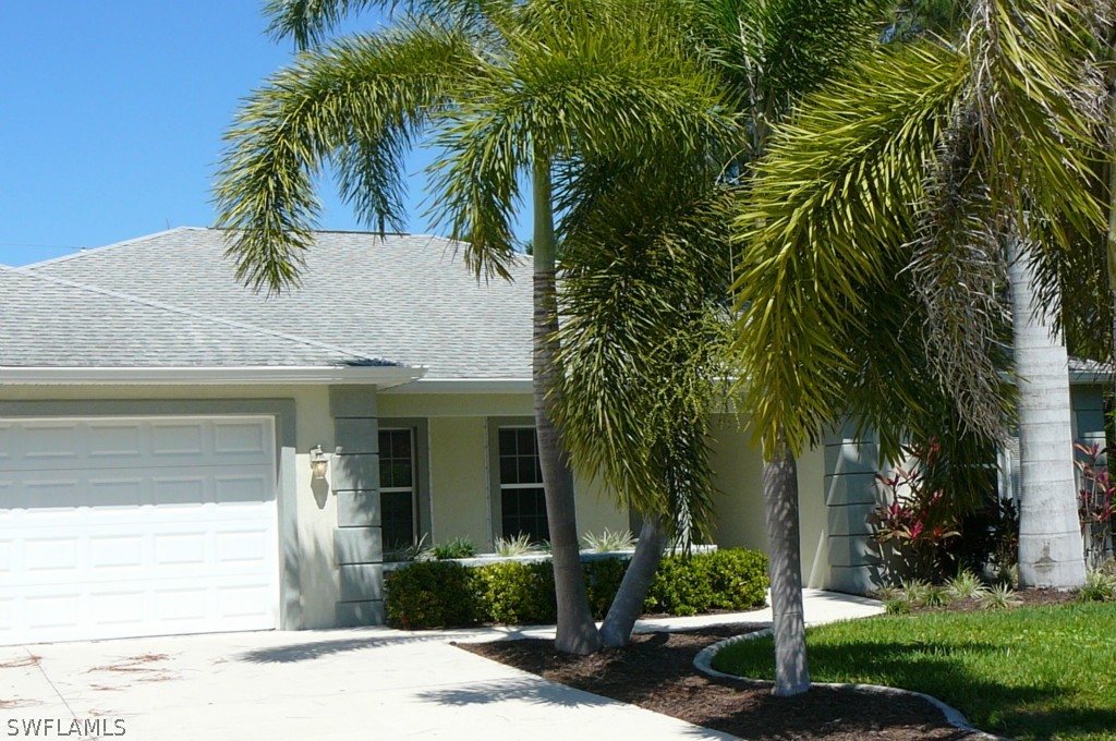 8221 Matanzas Road Fort Myers, FL 33967 - Photo 1 of 24 a view of a house with a yard and potted plants