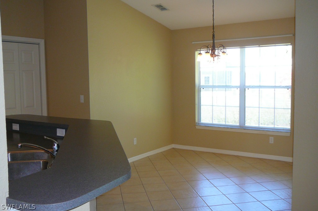 8221 Matanzas Road Fort Myers, FL 33967 - Photo 6 of 24 a view of a room with wooden floor and a window
