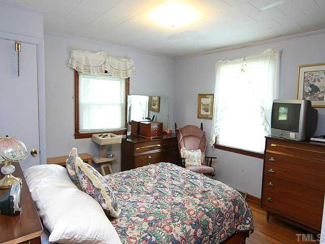 2135 Winkler Road Durham, NC 27712 - Photo 11 of 13 a bedroom with a bed and a flat screen tv