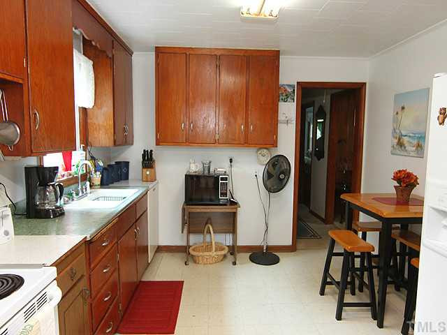 2135 Winkler Road Durham, NC 27712 - Photo 4 of 13 a kitchen with a table chairs and a stove top oven