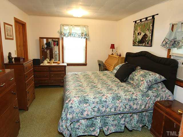2135 Winkler Road Durham, NC 27712 - Photo 8 of 13 a bed sitting in a bedroom next to a window