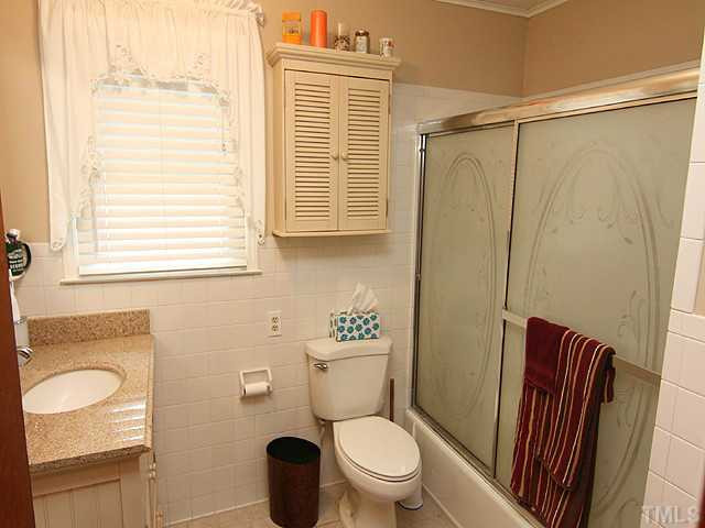 2135 Winkler Road Durham, NC 27712 - Photo 9 of 13 a bathroom with a toilet a sink and a shower
