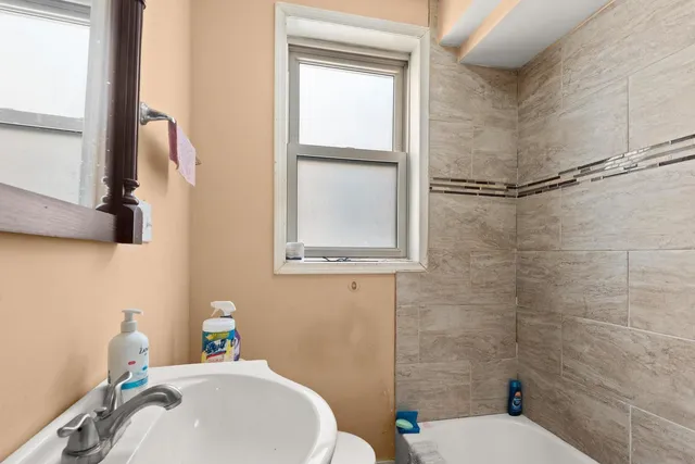 a bathroom with a sink toilet and shower