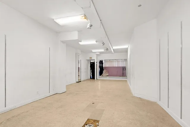 a view of a hallway with room and a window