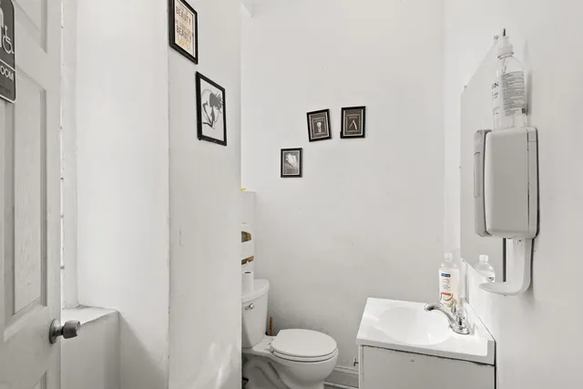 a white toilet sitting next to a bathroom sink